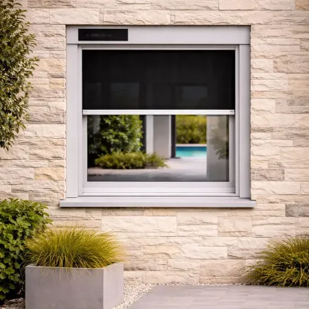 Moustiquaire enroulable solaire RAL 9006 aluminium vue de face sur façade en pierre avec toile noire partiellement ouverte