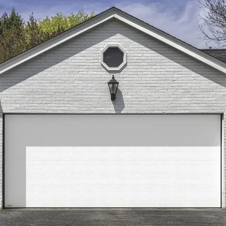 Porte de garage sectionnelle blanche installée sur maison en brique avec façade classique et extérieur résidentiel soigné