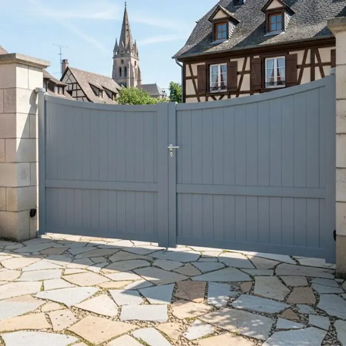 Portail aluminium GALAPE gris devant une maison à colombages