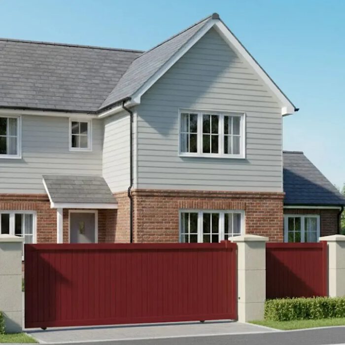 Portail aluminium NATI bordeaux devant une maison à bardage
