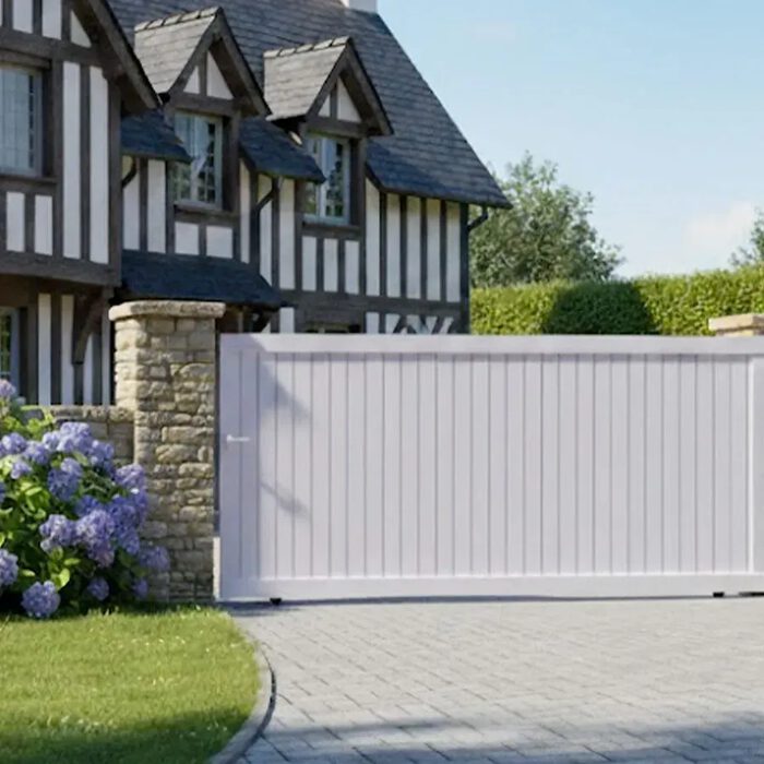 Portail coulissant NATI blanc devant une maison normande