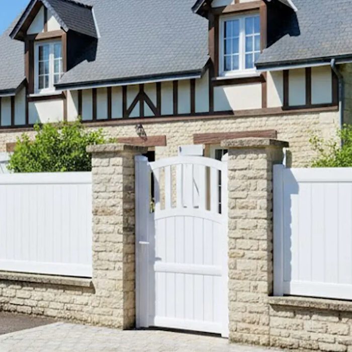 Portillon aluminium TOM blanc devant une maison normande