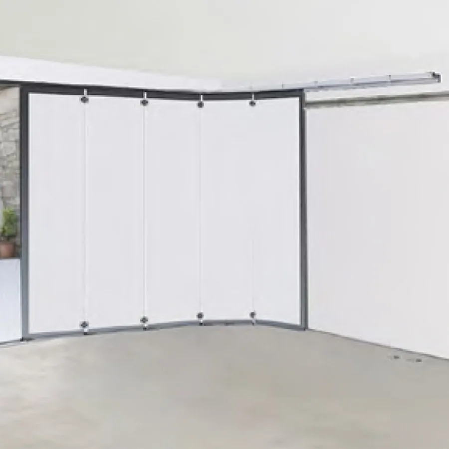 Vue intérieure d'un garage avec porte à enroulement latéral repliée le long de la paroi, plafond entièrement libre
